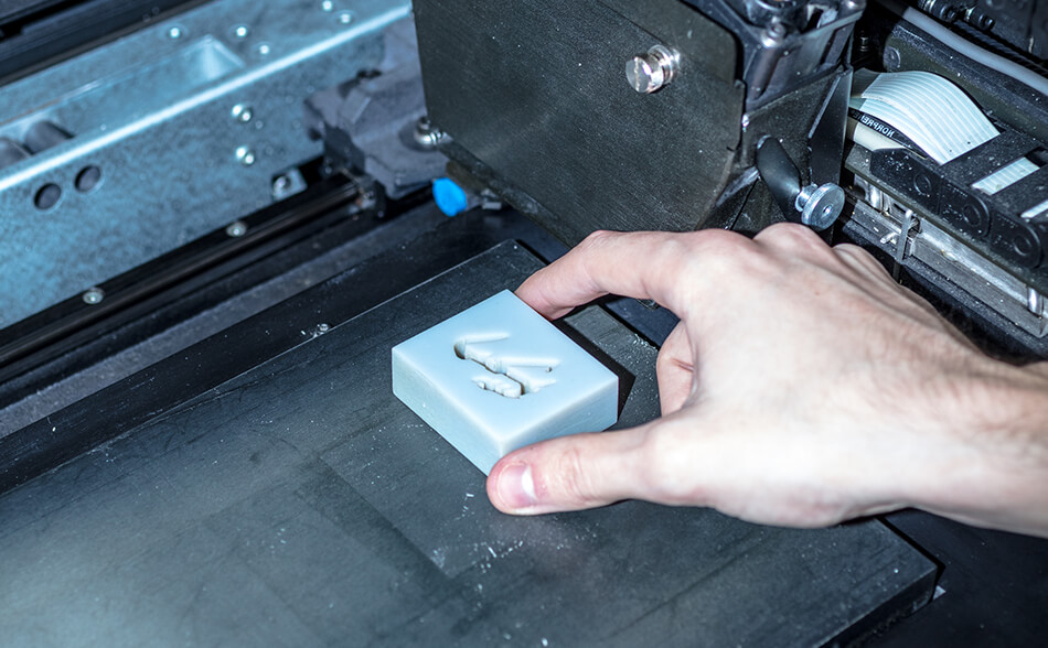 Product being removed from laser cutter